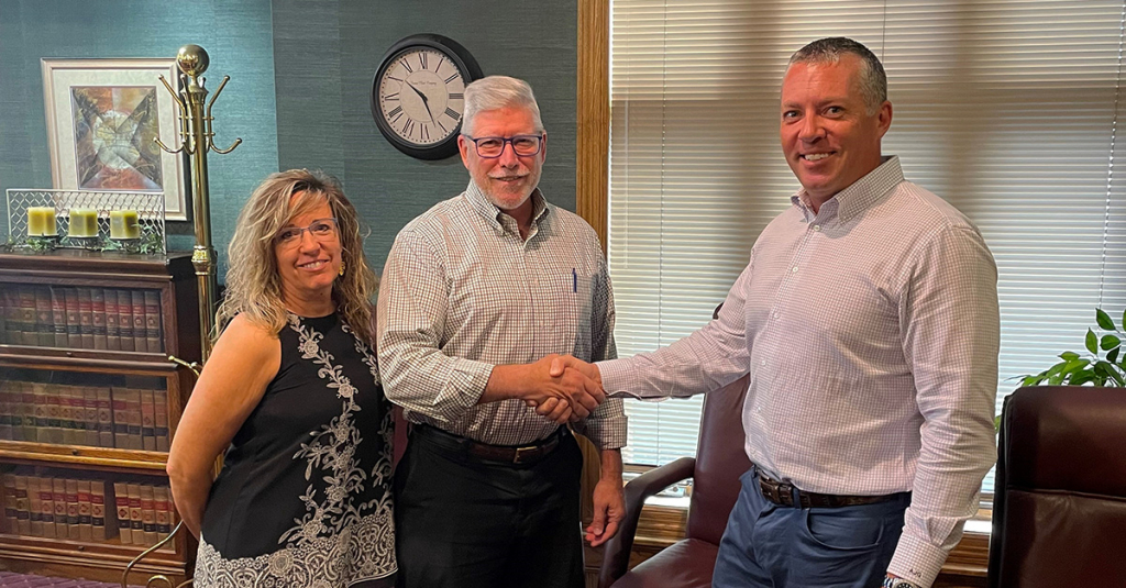 Principal and Co-Founder Adam Gibbs shaking hands with clients at a closing