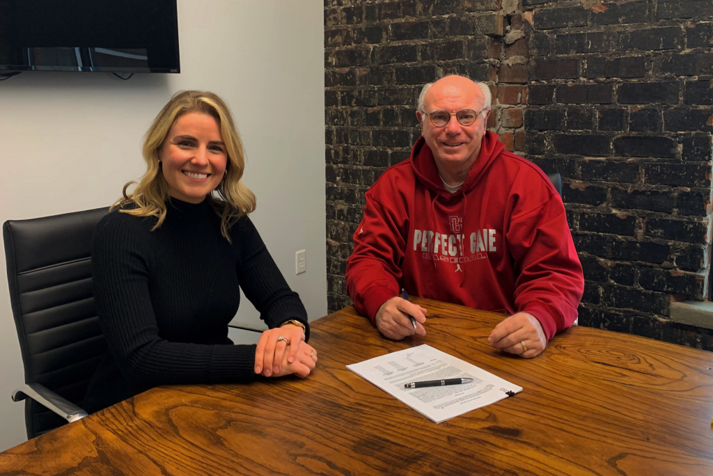 Principal Erica Seelman sitting with a client that just signed a lease